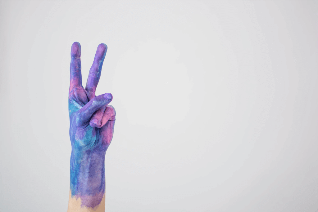 hand with painting making peace sign