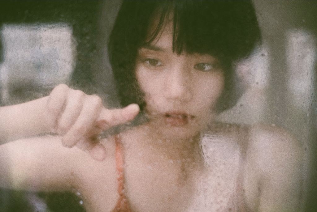 woman touching wet window