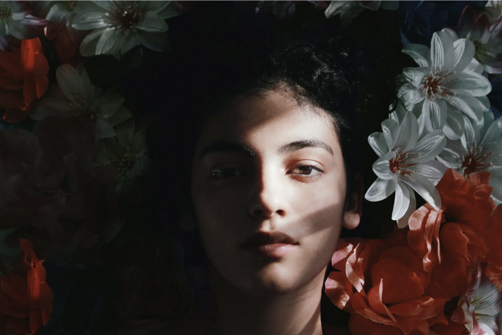 woman lying beside flowers