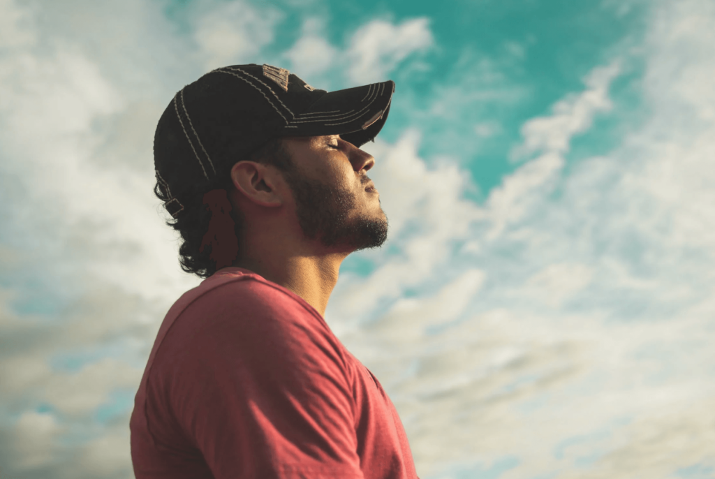 side profile of.a man with sky background