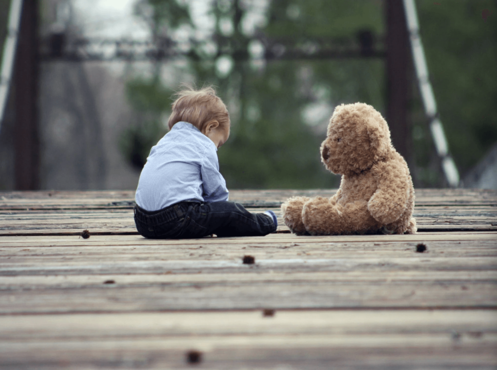 Little boy sitting with a teddy bear