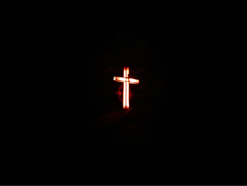 A red glowing cross in the night sky