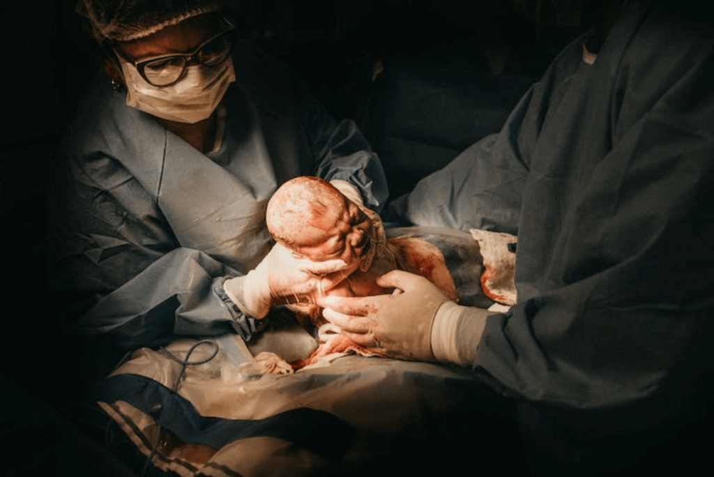 doctors holding a newborn baby