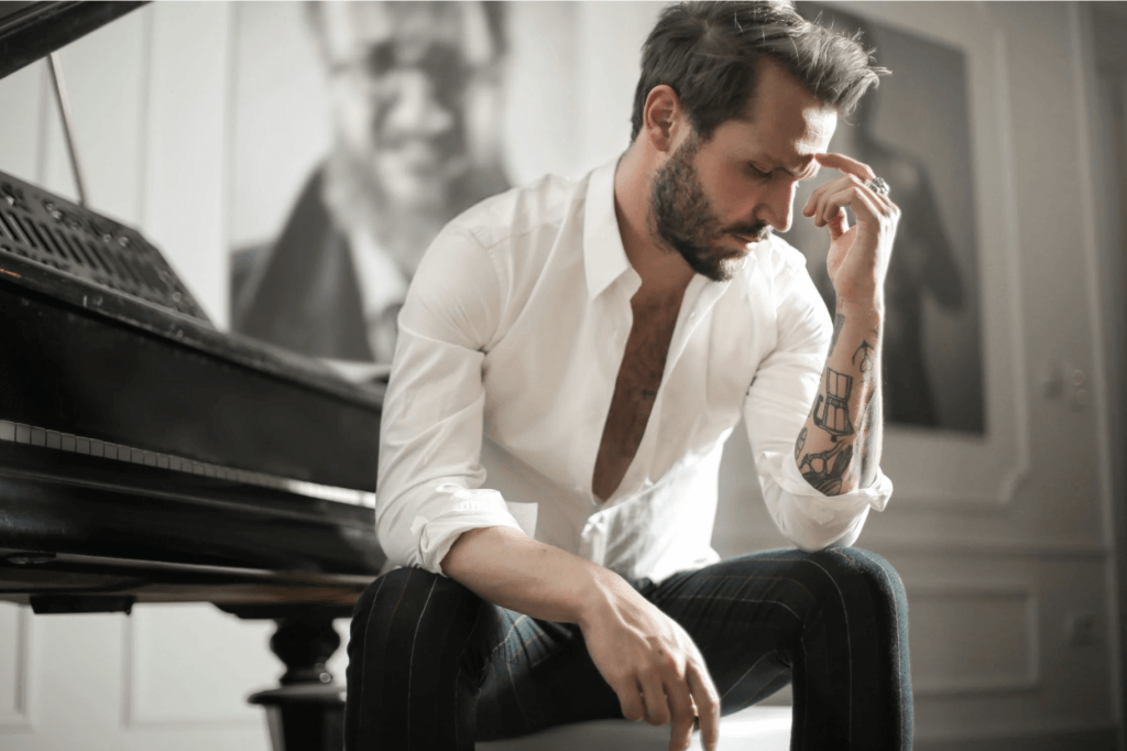 frustrated man sitting by a piano