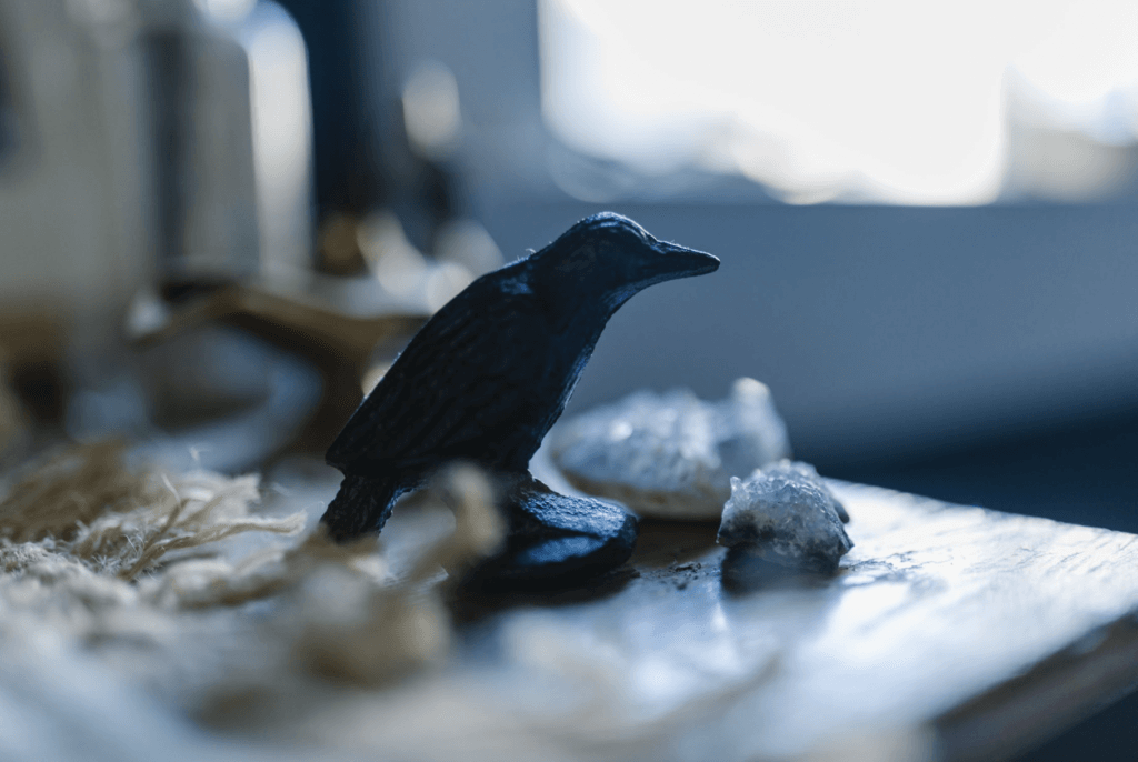 crow figurine on a table